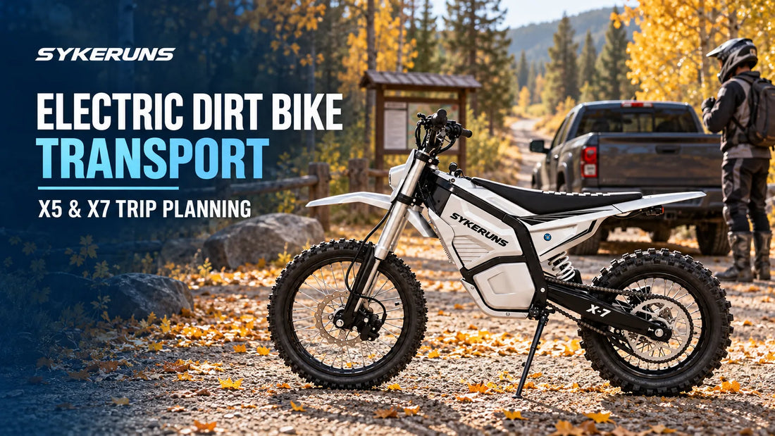 Silver-white SYKERUNS X7 electric dirt bike parked near a pickup truck and a rider wearing protective gear at an autumn forest trailhead.
