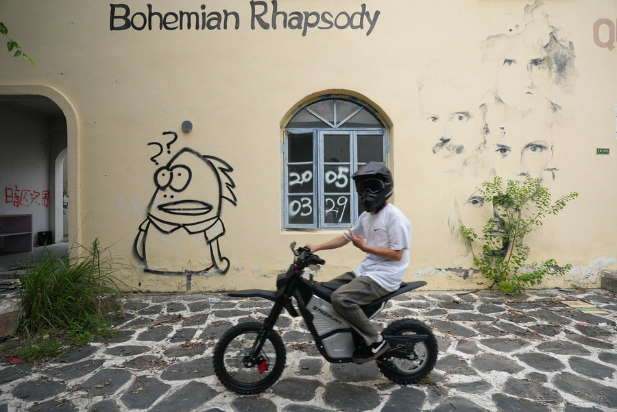 Front view of a helmeted rider on a SYKERUNS X5 electric dirt bike